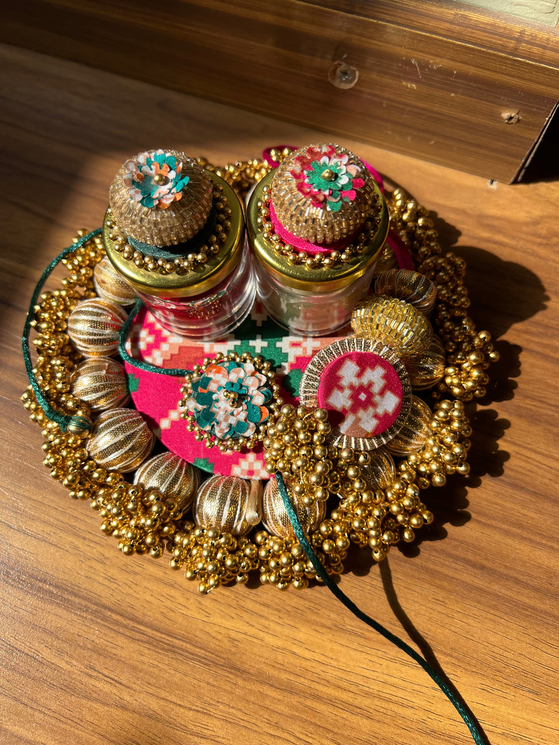 Joker Poker Rakhi set: Bottle Green + Pink Navratna Patola