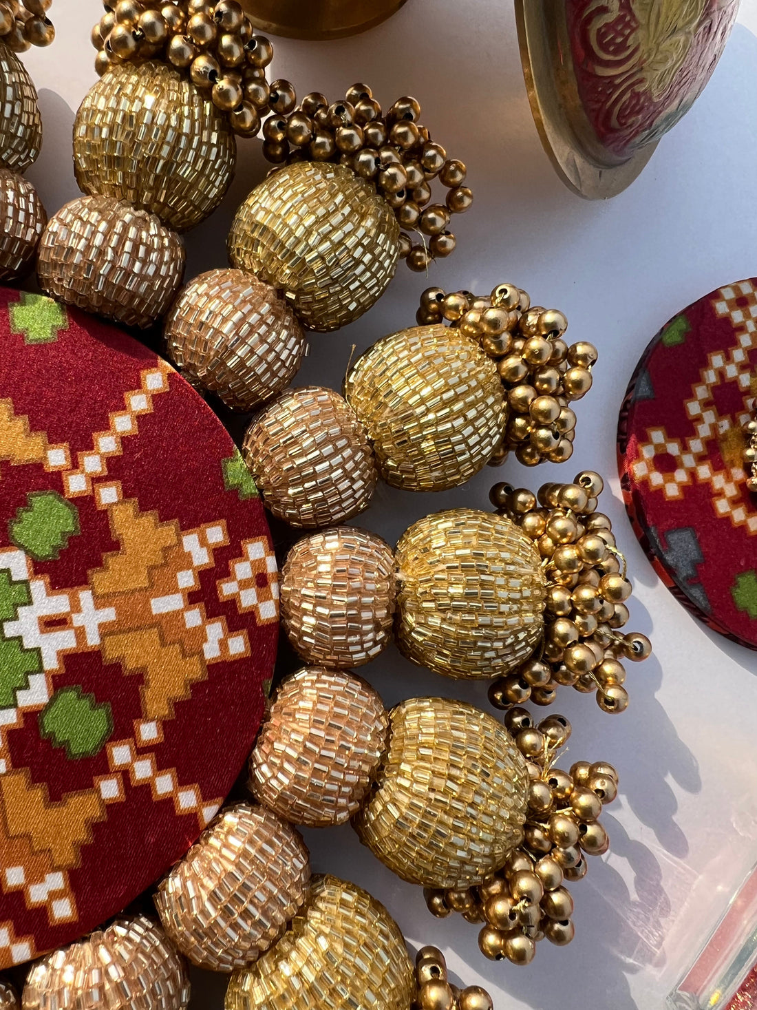 Spherical Chaandbali OG Inflorescence Divine Pichwai and Maroon Navratna Patola Diya Pallet