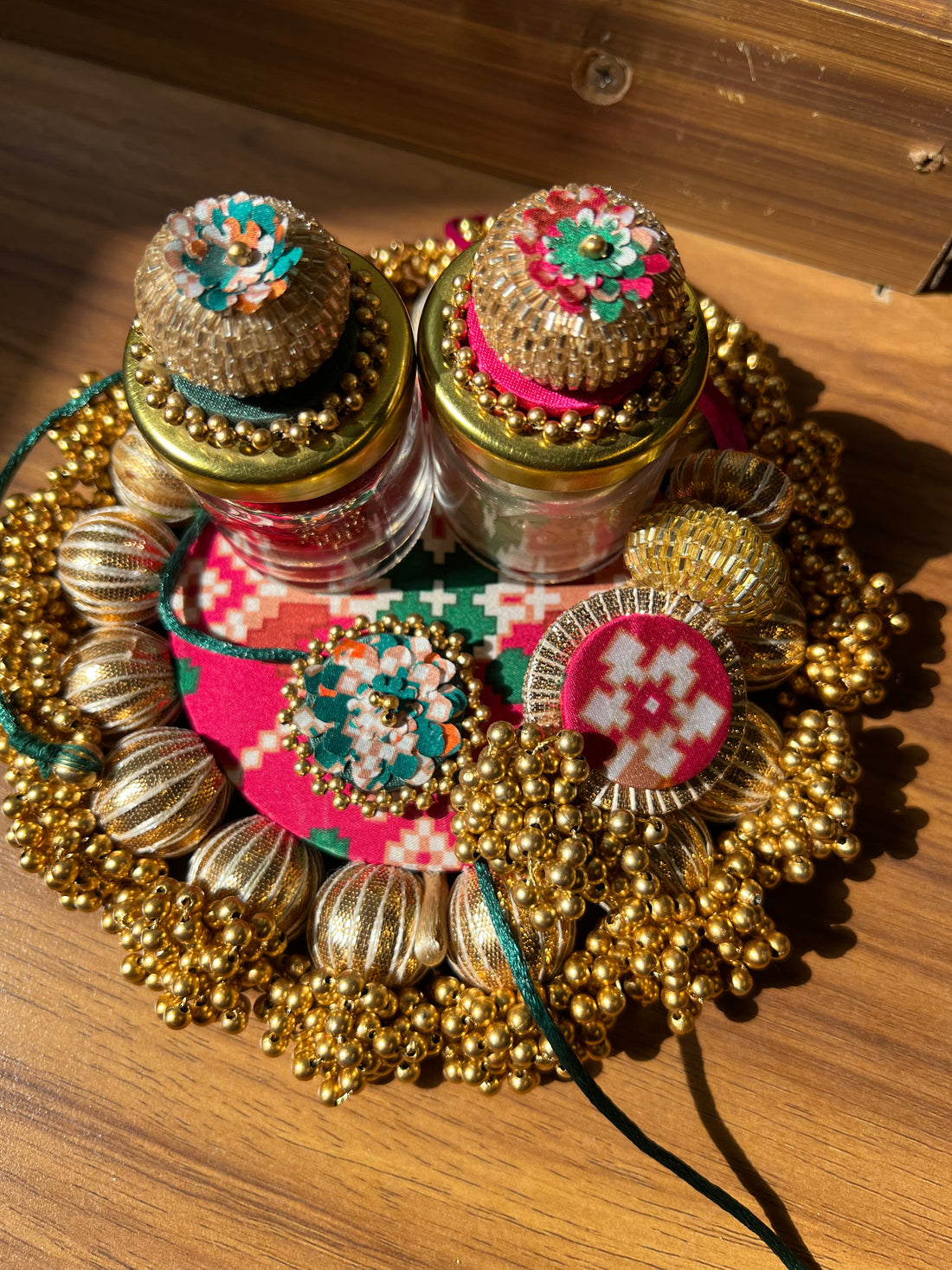 Joker Poker Rakhi set: Bottle Green + Pink Navratna Patola